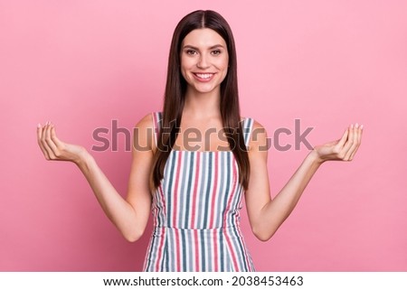 Portrait of attractive brown-haired cheerful girl showing peace sign isolated over pink pastel color background