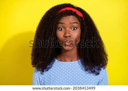 Photo portrait of curly girl in dotted blouse sending air kiss pouted lips isolated on bright yellow color background