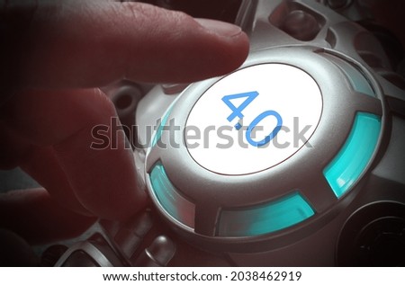Finger about to press a car ignition button with the numbers "4.0". Composite image between a hand photography and a 3D background. Concept of Industry 4.0. 