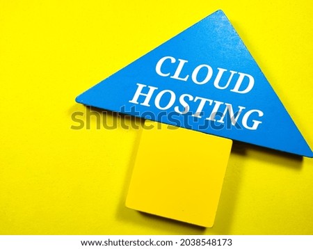 Business concept.Text CLOUD HOSTING writing on colored tangram on a yellow background.