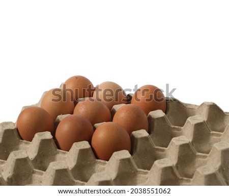 Eggs in a brown cardboard tray, 6 eggs, the rest of the space where the eggs have been eaten.
