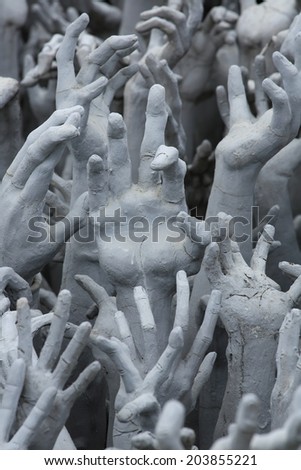Conceptual sculpture representing hand from hell suffering, asking for help at Rongkhun Temple, Chiangrai 