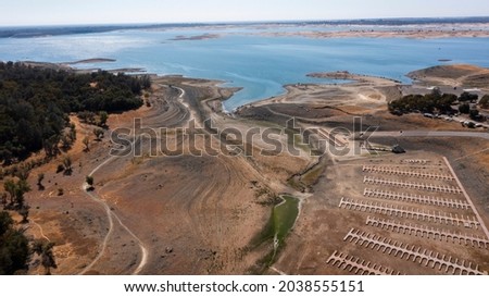 Aerial view of the severe drought conditions of Folsom Lake, a reservoir in Folsom, California, USA. Royalty-Free Stock Photo #2038555151
