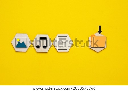 A picture of picture, music, document and save file symbol on yellow background