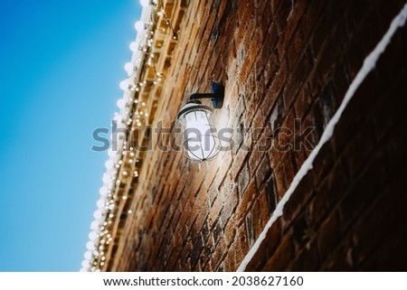 Street lamp on a brick wall. Minimalistic picture. New Year's mood. High quality photo