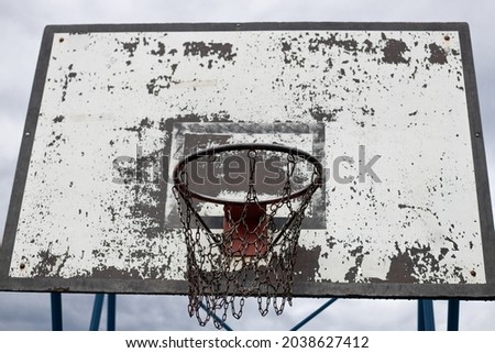 Basketball backboard and basketball hoop with chain net after the rain. Royalty-Free Stock Photo #2038627412