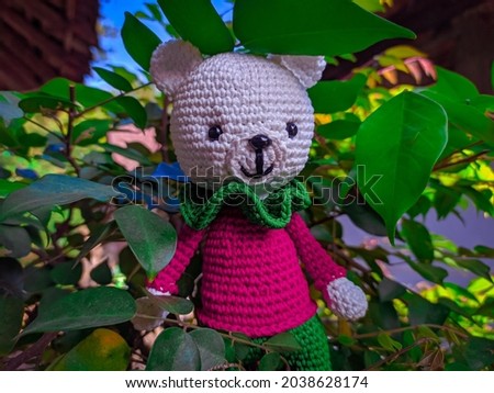 Handmade crochet toys. cute and small animal amigurumi doll on nature background.