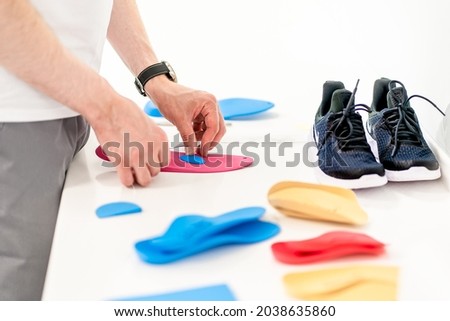 Orthopedic insoles. Fitting orthotic insoles. Flatfoot treatment. Podiatry clinic Royalty-Free Stock Photo #2038635860