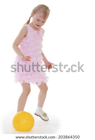 Girl in pink dress playing with a ball.Happiness concept,happy childhood