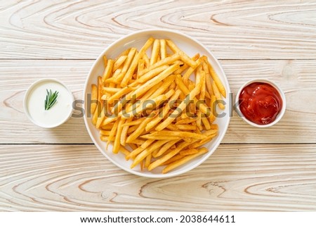 French fries or potato chips with sour cream and ketchup Royalty-Free Stock Photo #2038644611