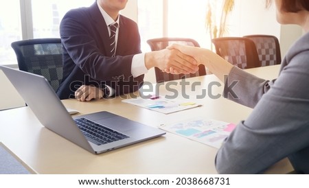 Couple of businessperson shaking hands in the meeting room. Royalty-Free Stock Photo #2038668731