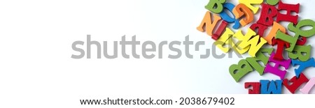 Wooden colored letters on a white background in various places. Copy Space.