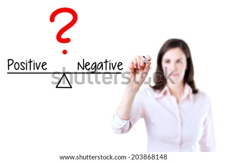 Young business woman writing positive and negative compare on balance bar. Isolated on white background.