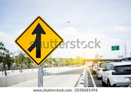 Merge road sign as symbol of cooperation. Merging Sign, Road, Diamond Shaped, Directional Sign. Business decisions concept with traffic sign