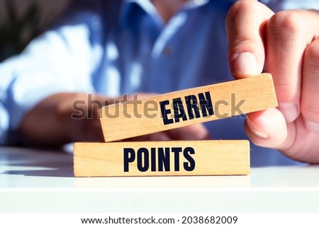 Word, writing, text Earn Points. Conceptual photo Loyalty Reward Benefit Program For Earning Customer Point written wooden block Holding Hand with Finger.