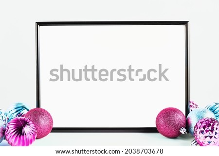 holiday mock up. black frame with blank white background for text. christmas decor pink and blue, copy space.