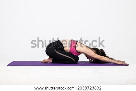 Young woman doing yoga practice isolated on white background. Concept of healthy life and natural balance between body and mental development.