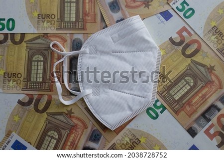 face mask lies on 50 euro banknotes