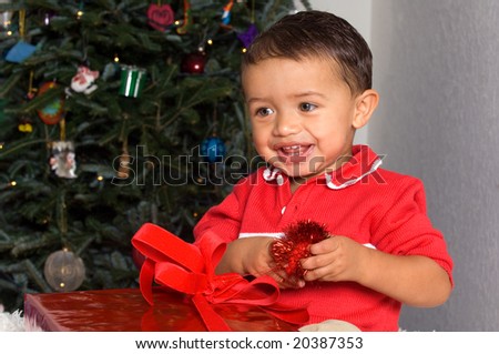 Adorable Baby Boy Smiling with Christmas gift