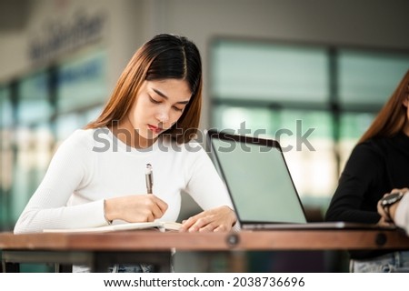 Beautiful Asian female student sit for exam at university classroom students sitting in the row education lifestyle university college