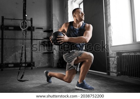 sport, bodybuilding, fitness and people concept - young man exercising with medicine ball in gym Royalty-Free Stock Photo #2038752200