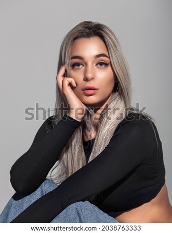 Beautiful model girl with long ash blond hair .Beauty woman with hairstyle dye. Fashion, cosmetics and makeup. Healthy clean skin. Blue eyes and full big lips. Royalty-Free Stock Photo #2038763333