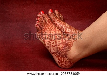 Lady Hand  Feet with Indian Heena In Indian wedding with Red Background | isolated beautiful feet and hand 