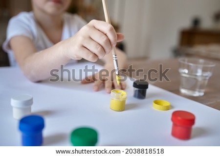 Little boy drawing with gouache, kids in workshop