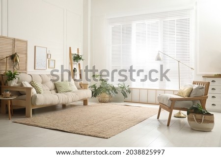 Comfortable sofa and armchair in stylish living room. Interior design Royalty-Free Stock Photo #2038825997
