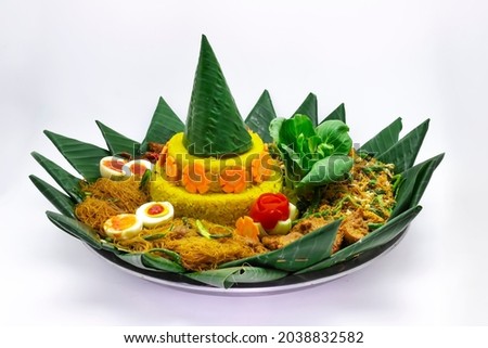 Nasi Tumpeng is indonesian cuisine Yellow rice in a cone shape on banana leaf for celebration Royalty-Free Stock Photo #2038832582