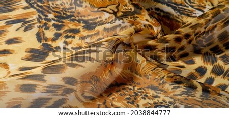 African fabric with silk tiger print. This amazing fabric will help you plunge into the world of the wild savannah. background pattern