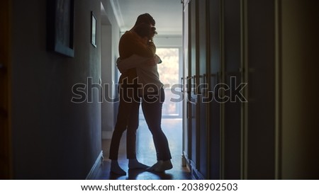 Sad Couple Embracing, Comforting Each other in Difficult Times. Family Overcoming Difficulties Together, Tender Moment. Atmosphere of Sadness and Tragedy. Moment of Human Drama Royalty-Free Stock Photo #2038902503