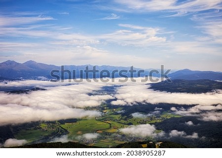 Great view of the foggy valley.  Dramatic scene. Beauty world. Aineck, Austria, Europe.