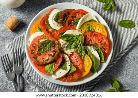Healthy Homemade Heirloom Tomato Caprese Salad with Basil and Mozzarella Royalty-Free Stock Photo #2038924316