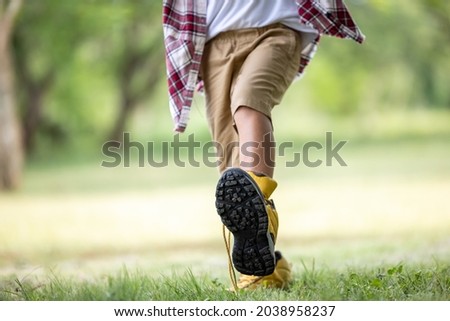  a boy wearing hiking shoe father walking in the park selective focus  
