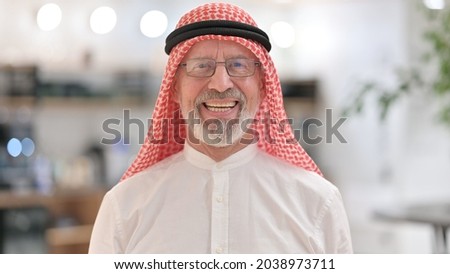 Portrait of Smiling Old Arab Businessman Looking at Camera  Royalty-Free Stock Photo #2038973711