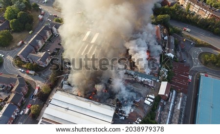 A Drone shot of a building on fire in Kidderminster, UK. High quality large warehouse fire in urban area.