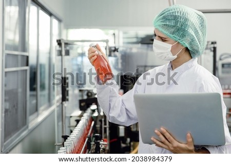 Quality control and food safety inspector test and check product contaminate standard in the food and drink factory production line with hygiene care. Royalty-Free Stock Photo #2038984379