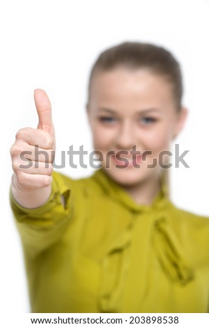 Happy smiling girl showing thumb up hand sign, isolated