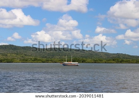 A lone boat anchored in a calm river