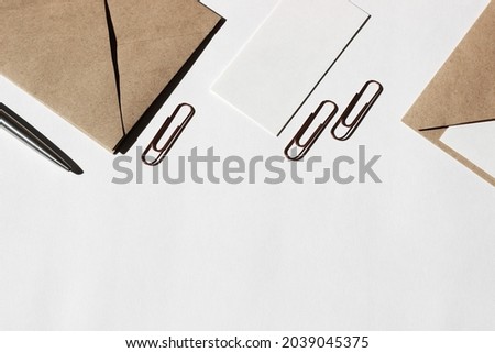 Minimal Mockup Border Design with Stationery. White Blank Cards, Envelopes, Clips on White Background with Copy Space.