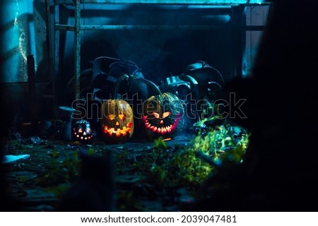 scary art halloween pumpkins in smoke and darkness by candlelight in a scary abandoned place