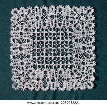 Russian lace is a bobbin tape lace. The designs of Russian lace are of abstract form Royalty-Free Stock Photo #2039052221