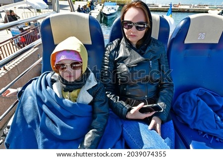 Child girl with mom on a boat trip.