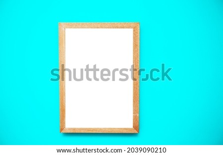 Empty white frame over turquoise background.