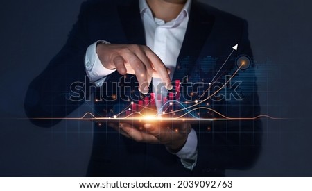Businessman Holding Tablet with Growing Virtual Hologram of Statistics, Graph and Chart. Business Strategy Development and Growing Growth Plan.