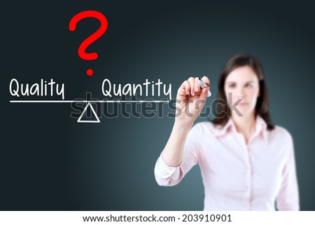 Young business woman writing quality and quantity compare on balance bar. Blue background.