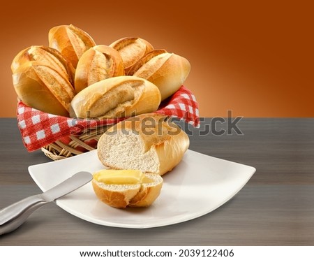 Basket of bread and bread with butter on table background. Royalty-Free Stock Photo #2039122406