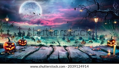 Halloween Landscape - Table And Graveyard In Spooky Night  Royalty-Free Stock Photo #2039124914