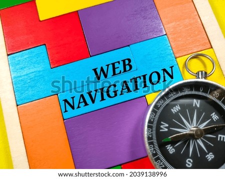 Business concept.Text WEB NAVIGATION with compass and wooden puzzle on yellow background.